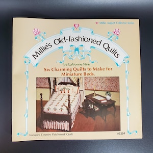 May include: A book titled "Millie's Old-fashioned Quilts" by LaVonne Nye. The book cover features a miniature bed with a quilt and a small table with a lamp and a book. The book includes instructions for making six charming quilts for miniature beds.  The book cover also includes the text "Millie August Collector Series" and "Includes Country Patchwork Quilt".