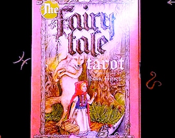 May include: The Fairy Tale Tarot deck box features a pink background with a whimsical illustration of a wolf and Little Red Riding Hood in a forest setting. The text on the box reads "The Fairy Tale Tarot" and "Lisa Hunt".