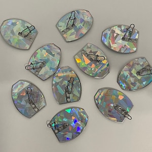 May include: Ten iridescent holographic oval-shaped fishing lures with black swivels and silver rings.