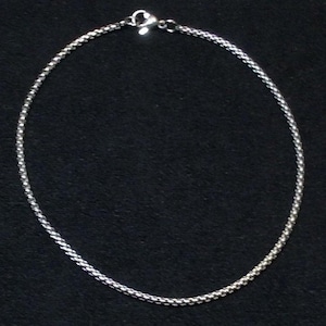 May include: A silver chain necklace with a lobster clasp.