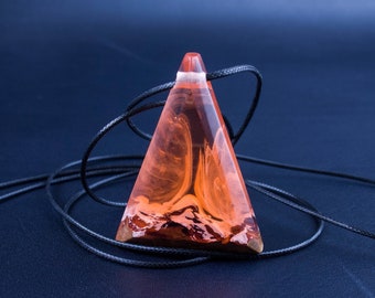 Stylish orange resin pendant on wood necklace.A gift for her, showcasing her unique style and taste with this stunning resin jewelry piece.