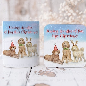 May include: A white ceramic mug and a square coaster featuring a watercolor illustration of three dogs with festive accessories. The text "Having doodles of fun this Christmas" is written in red.