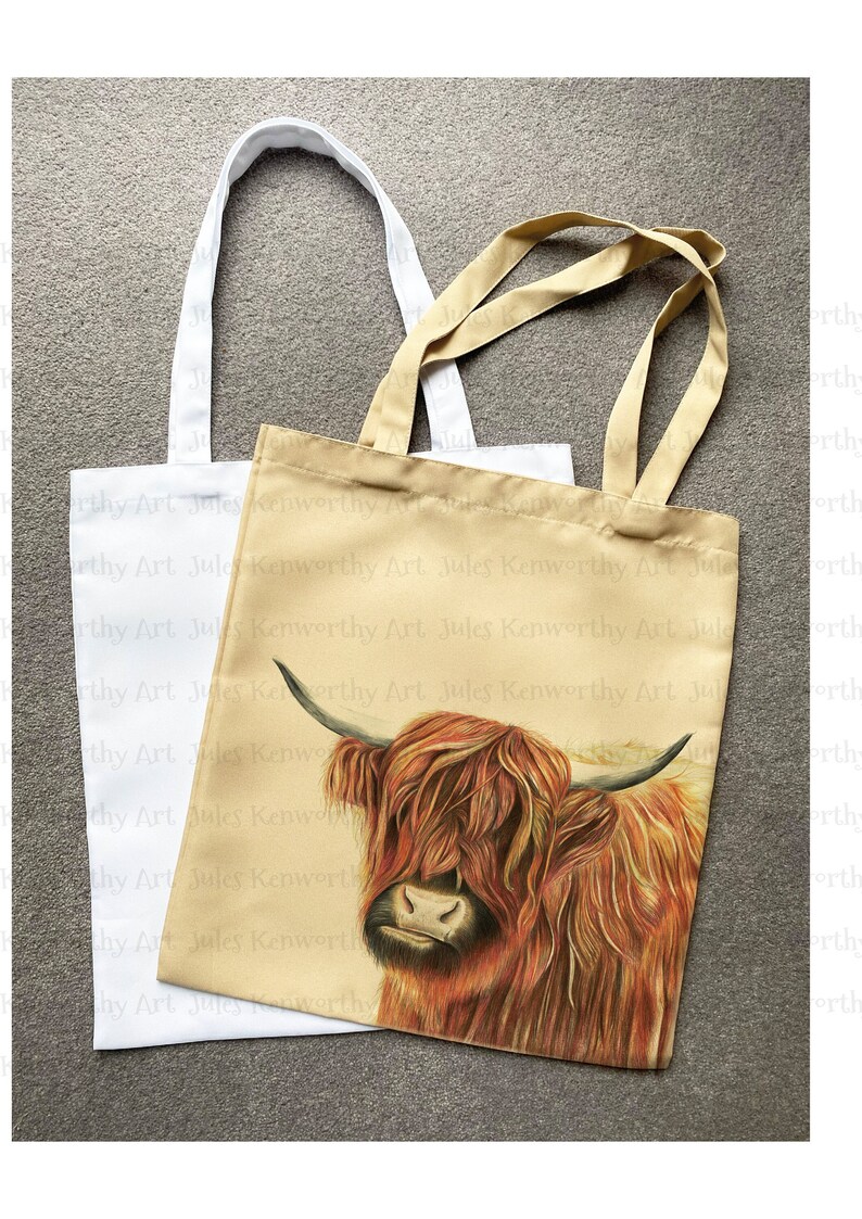May include: Two tote bags, one white and one beige. The beige bag has a printed image of a Highland cow with brown and red fur. The text "Jules Kenworthy Art" is repeated on the beige bag.