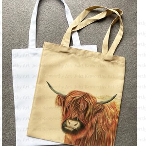 May include: Two tote bags, one white and one beige, with the text "James Kenworthy Art" repeated on the beige bag. The beige bag features a close-up illustration of a Highland cow with a reddish-brown coat and long, shaggy hair.