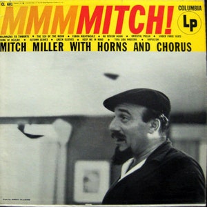 May include: A yellow and red album cover with the text "MMM Mitch!" and "Mitch Miller with Horns and Chorus". The cover features a black and white photo of a man wearing a hat and a suit.