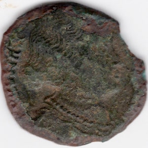May include: A copper coin with a worn, green patina. The coin features a profile of a person with a crown on their head. The coin is slightly damaged on the edge.