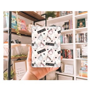 May include: A white and pink phone case with a repeating pattern of coffee cups, hearts, and the text "Coffee is brewing".