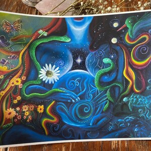May include: A colorful painting depicting a woman with a glowing orb in her hands. The woman is surrounded by snakes, flowers, butterflies, and a hummingbird. The background is a dark blue with stars and swirls.