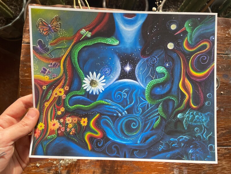 May include: A colorful, abstract painting depicting a woman with two snakes wrapped around her. The woman is holding a blue orb in her hands, and the background is filled with stars and other celestial imagery.