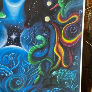 May include: A colorful abstract painting with a woman's torso in the center. The woman's body is surrounded by a swirling rainbow, a green snake, a blue turtle, and a green hummingbird. The background is a dark blue with white stars.