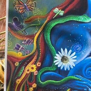 May include: A colorful abstract painting with a green snake, a white daisy, and a butterfly. The painting features a variety of colors, including red, orange, yellow, green, blue, and purple. The snake is coiled around the daisy, and the butterfly is flying above them. The painting is a beautiful and intricate work of art.
