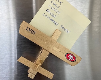 Any sports team, company logo or saying on a wooden clothespin plane!