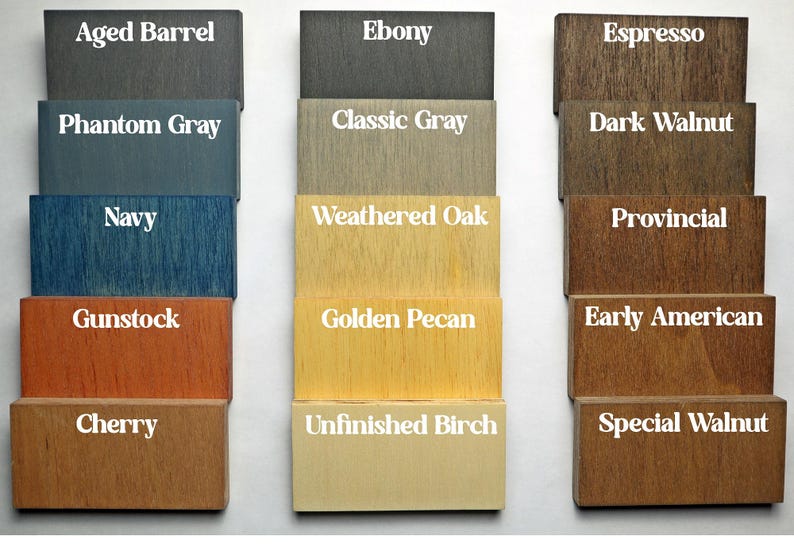 May include: A colour chart displaying 15 different wood stain colours. The colours are arranged in three columns, with five colours in each column. The colours are: Aged Barrel, Phantom Grey, Navy, Gunstock, Cherry, Ebony, Classic Grey, Weathered Oak, Golden Pecan, Unfinished Birch, Espresso, Dark Walnut, Provincial, Early American, and Special Walnut.