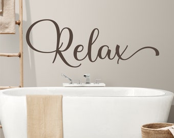 May include: A dark brown wall decal featuring the word Relax in a cursive script font. The lettering is applied to a smooth surface above a white bathtub, displaying a decorative design element intended for interior wall decoration.