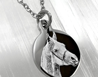 May include: A silver necklace with a round pendant featuring an engraved image of a horse's head.