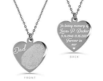 May include: Silver heart-shaped necklace with a fingerprint and the word "Dad" on the front. The back of the necklace has the inscription "In loving memory of Lucas P. Decker 9.14.1946-11.16.2021 Forever in our hearts".