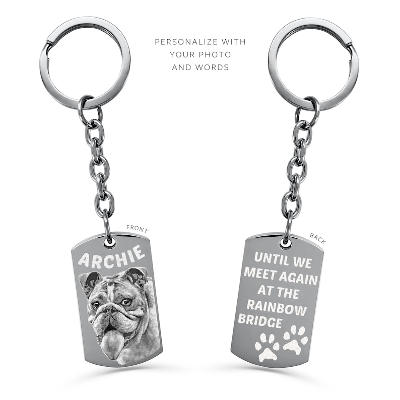 May include: Silver keyring with a photo of a bulldog on the front and the text "Archie". The back of the keyring has the text "Until we meet again at the rainbow bridge" with paw prints.