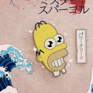 May include: A yellow cartoon character with large eyes and a wide smile, inspired by the Great Wave off Kanagawa, a famous Japanese woodblock print. The character is set against a background of a blue wave and a red sun. The text "ミスター スーパール" is written in Japanese above the character.