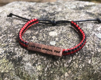 May include: Red and black braided bracelet with a wooden tag that says "Love you always, Dad".