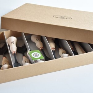 May include: A set of 10 wood carving tools with copper accents, organised in a cardboard box with a label that reads "Leather Carving Tools".