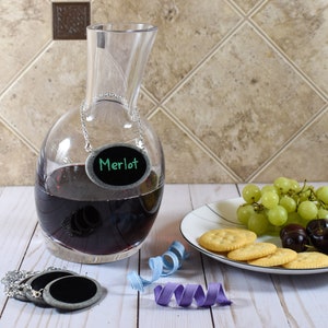 Decanter tag on wine decanter with plate of food