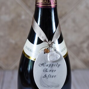 Wedding tag hanging around neck of wine bottle.