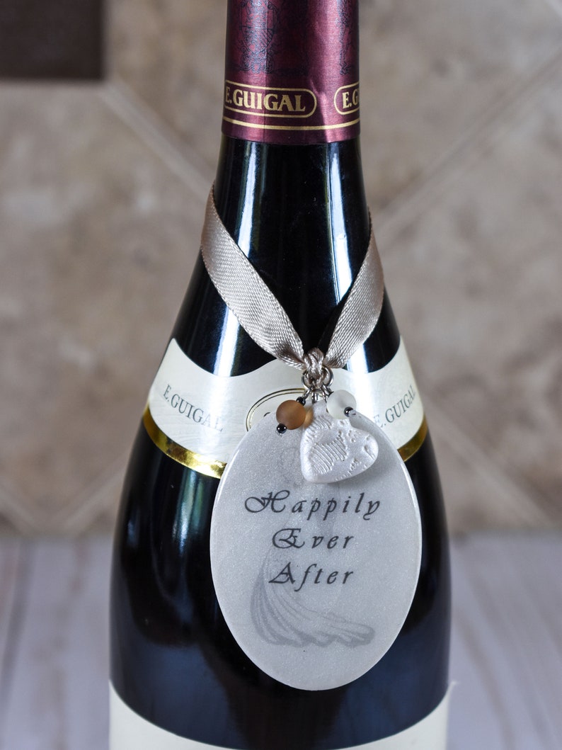 Wedding tag hanging around neck of wine bottle.