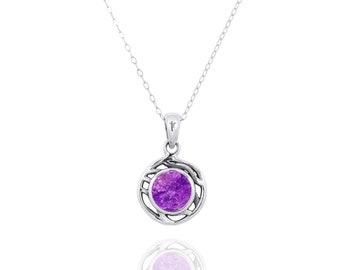 May include: A silver chain necklace with a pendant featuring a purple stone set in a silver filigree design.