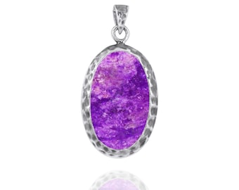 May include: A silver pendant with a hammered oval frame and a purple and white gemstone.
