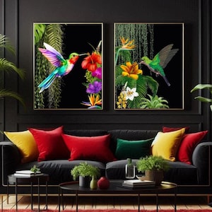 May include: Two framed prints of hummingbirds in a tropical setting. The prints are in black frames with gold trim. The hummingbirds are depicted in vibrant colours, with one hummingbird in green and the other in a rainbow of colours. The prints are hanging on a black wall above a black sofa with red, yellow, and green cushions.