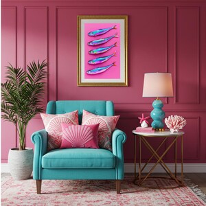 May include: A framed art print featuring five iridescent fish on a pink background hangs above a teal armchair with pink pillows. A teal lamp and coral decor sit on a side table. The room has a pink wall and a patterned rug.