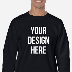 May include: A black sweatshirt with the text "YOUR DESIGN HERE" printed in white on the front.