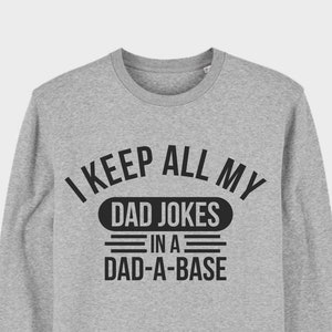 May include: A grey sweatshirt with the text "I keep all my dad jokes in a dad-a-base" printed on the front.