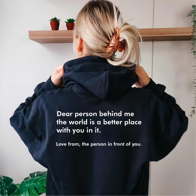 May include: Black hooded sweatshirt with the text "Dear person behind me the world is a better place with you in it. Love from, the person in front of you."