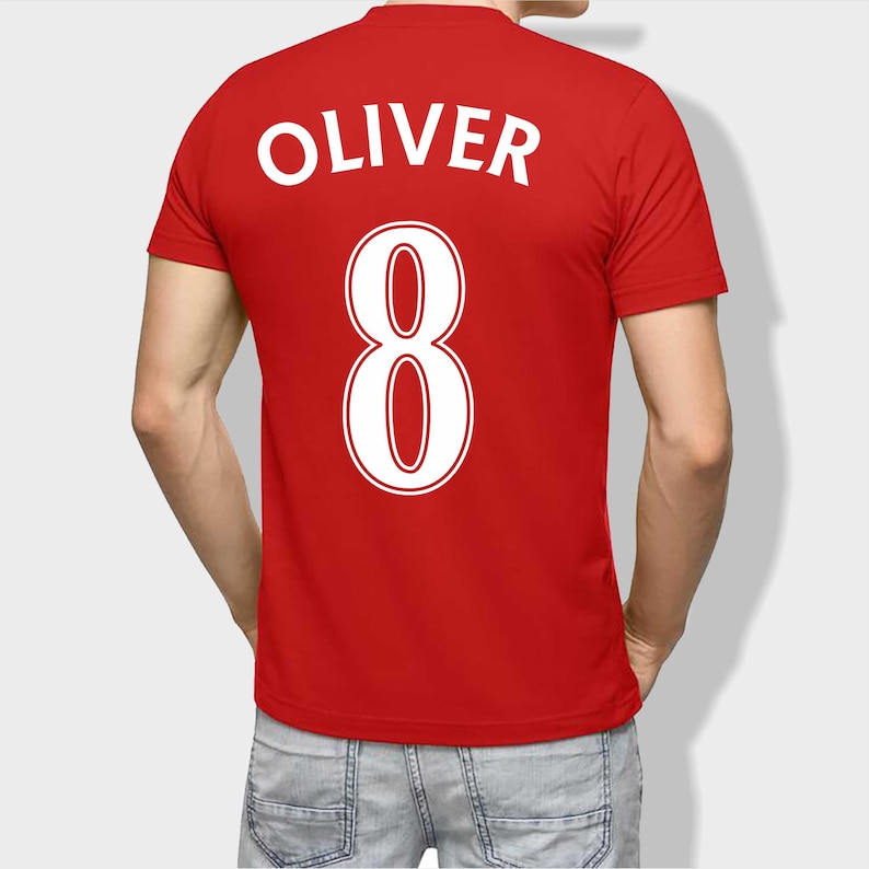 May include: Red t-shirt with the name "Oliver" and the number "8" printed on the back in white.