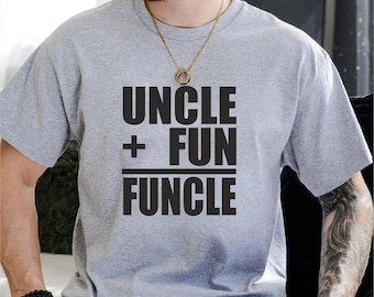 May include: A light gray t-shirt with the text "UNCLE + FUN = FUNCLE" in bold black letters. The shirt has short sleeves and a crew neck. The design is centered on the front of the shirt.