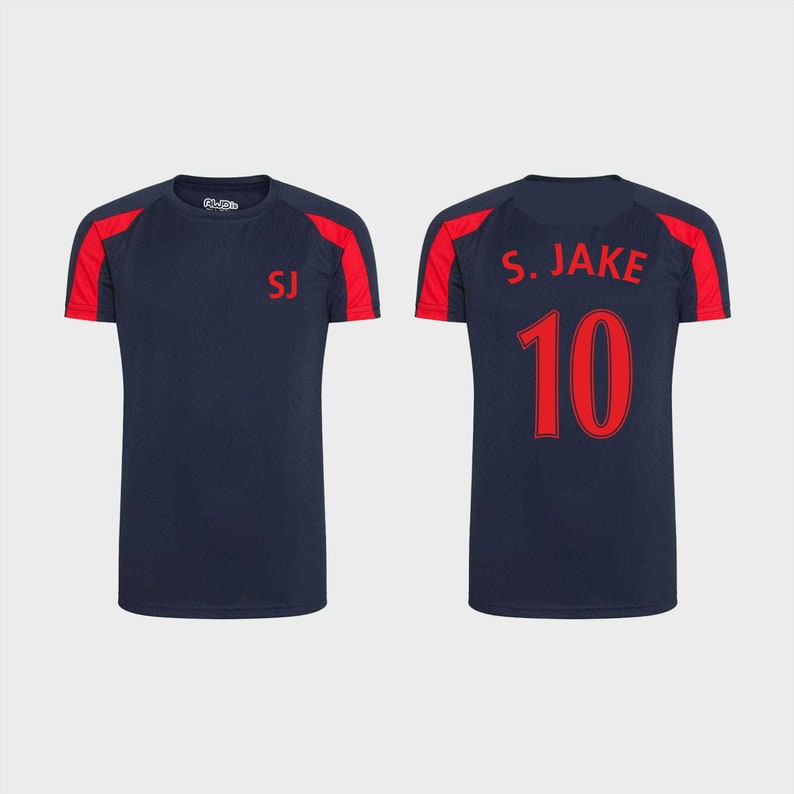May include: Two navy blue t-shirts with red accents. One shirt has the initials "SJ" on the front and the other has "S. JAKE 10" on the back.
