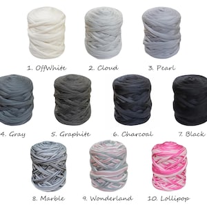 May include: Ten skeins of yarn in various colors, including off-white, gray, black, and pink. The yarn is arranged in two rows of five skeins each. The skeins are labeled with numbers and names, such as "OffWhite", "Cloud", "Pearl", "Gray", "Graphite", "Charcoal", "Black", "Marble", "Wonderland", and "Lollipop".