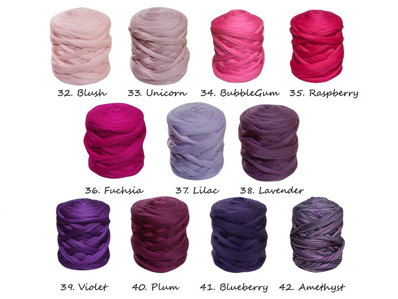 May include: Twelve skeins of yarn in various shades of pink, purple, and blue. The yarn is arranged in four rows of three skeins each. The skeins are labeled with numbers and names, such as "Blush", "Unicorn", "BubbleGum", "Raspberry", "Fuchsia", "Lilac", "Lavender", "Violet", "Plum", "Blueberry", and "Amethyst".