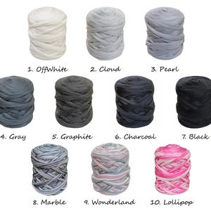 May include: Ten balls of yarn in a variety of colours, including off-white, grey, black, and pink. The yarn is arranged in two rows of five balls each. The balls are labelled with numbers and names, such as "OffWhite", "Cloud", "Pearl", "Grey", "Graphite", "Charcoal", "Black", "Marble", "Wonderland", and "Lollipop".