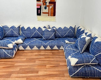 May include: A blue and white patterned sectional sofa with multiple cushions. The sofa is made of a soft, plush fabric and is perfect for lounging.
