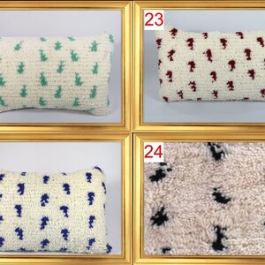 May include: Four white throw pillows with different colored patterns. The pillows have a fluffy texture and are arranged in a grid pattern. The pillows are numbered 21, 22, 23, and 24.