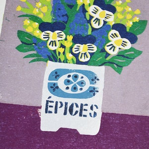 May include: A colorful floral print featuring a bouquet of flowers in a white vase with blue accents. The flowers include yellow, blue, and white blooms with green leaves. The word "&Eacute;PICES" is printed on the vase.