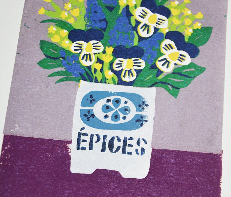May include: A colorful floral print featuring a bouquet of flowers in a white vase with blue accents. The flowers include yellow, blue, and white blooms with green leaves. The word "&Eacute;PICES" is printed on the vase.