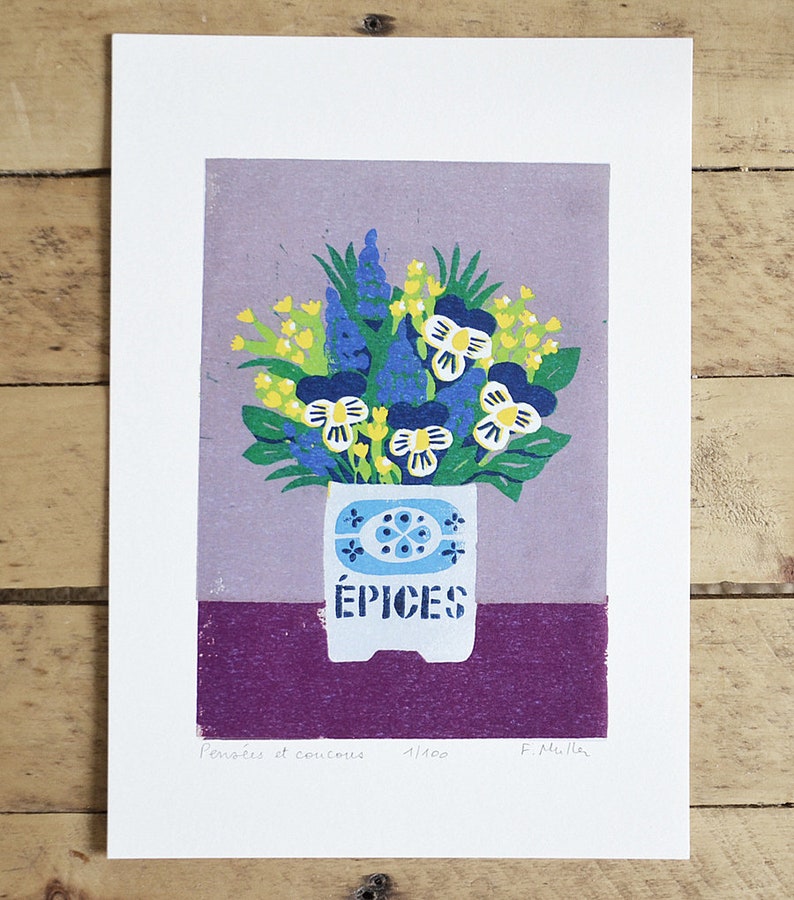 May include: A print featuring a floral arrangement in a white pot with the word "&Eacute;PICES" on it. The flowers are blue, yellow, and white, set against a purple background. The print is signed and numbered.