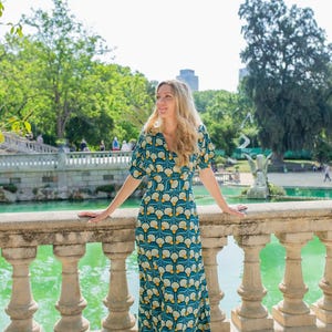 Rayon dress with a crossover neckline, bow at the back, and side pockets.