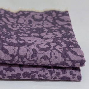 May include: A folded purple fabric with a marbled pattern. The fabric has a soft, textured surface.