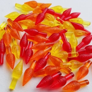 May include: A pile of red, orange, and yellow Christmas light bulbs with a textured, flame-like design.