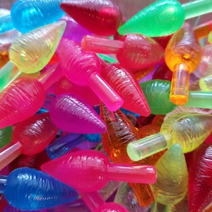 May include: A pile of colorful plastic Christmas light bulbs in the shape of a leaf. The bulbs are in various shades of red, orange, yellow, green, blue, and purple.