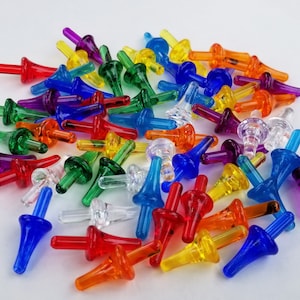May include: A collection of colorful plastic Christmas tree light bulb tips. The tips are in various colors, including red, orange, yellow, green, blue, purple, and clear.